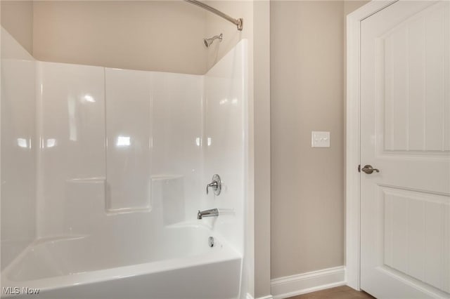 full bathroom featuring baseboards and shower / washtub combination