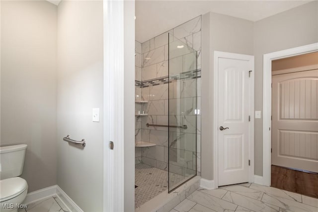 bathroom featuring marble finish floors, a stall shower, baseboards, and toilet