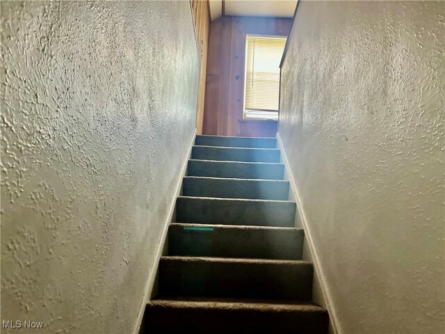 stairway with a textured wall