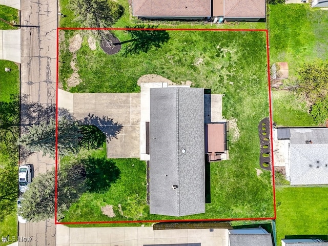 aerial view of property and surrounding area featuring property parcel outlined