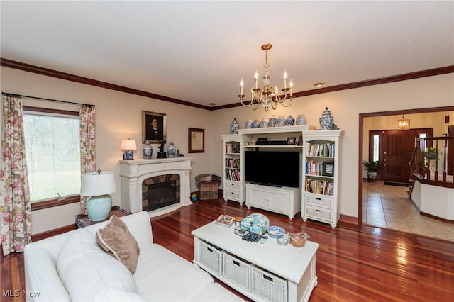 3286 Marks Rd, Medina, OH 44256 - living room featuring a chandelier, a fireplace, crown molding, and wood finished floors