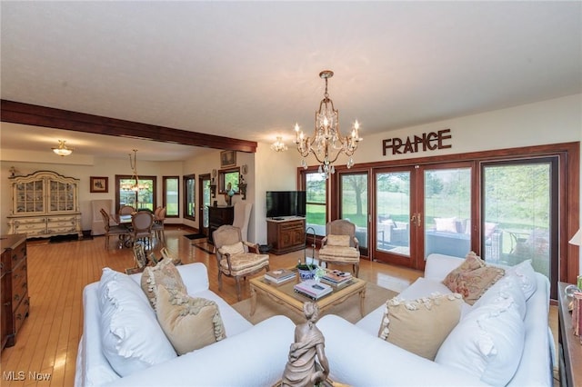 3286 Marks Rd, Medina, OH 44256 - living room featuring a chandelier, healthy amount of natural light, beamed ceiling, and light wood-type flooring