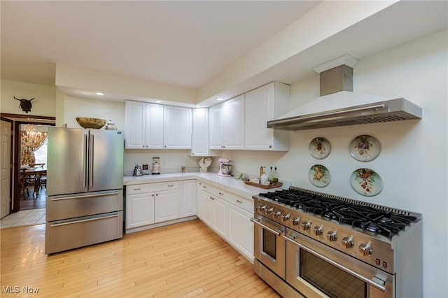 3286 Marks Rd, Medina, OH 44256 - kitchen featuring appliances with stainless steel finishes, wall chimney range hood, white cabinetry, light countertops, and recessed lighting