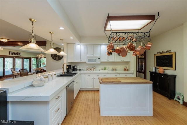 3286 Marks Rd, Medina, OH 44256 - kitchen featuring a sink, white microwave, butcher block countertops, a chandelier, and a peninsula
