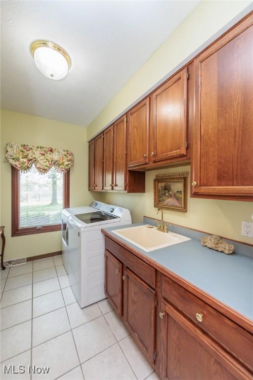 3286 Marks Rd, Medina, OH 44256 - laundry room with cabinet space, washing machine and dryer, and light tile patterned floors