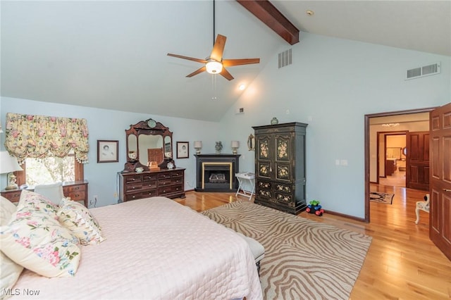 3286 Marks Rd, Medina, OH 44256 - bedroom featuring beam ceiling, high vaulted ceiling, light wood-style flooring, a fireplace, and a ceiling fan