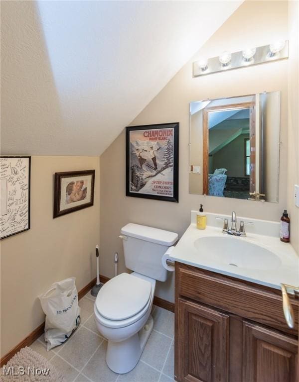 3286 Marks Rd, Medina, OH 44256 - bathroom with lofted ceiling, baseboards, toilet, vanity, and tile patterned flooring