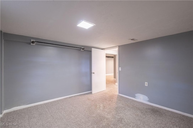 empty room with carpet and baseboards