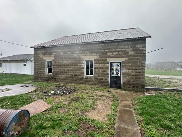 334 Cambridge St N, Cumberland, OH 43732 - rear view of house featuring metal roof and stone siding