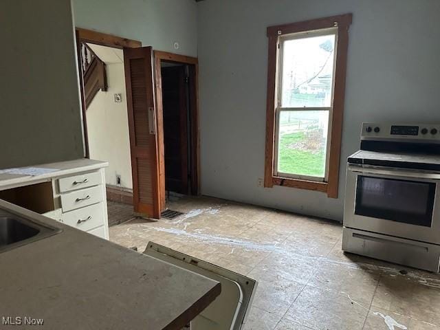 334 Cambridge St N, Cumberland, OH 43732 - kitchen with electric range, white cabinets, and light countertops