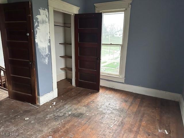 334 Cambridge St N, Cumberland, OH 43732 - unfurnished bedroom with baseboards, hardwood / wood-style floors, and a closet