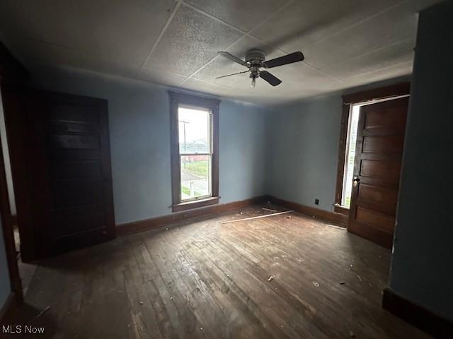 334 Cambridge St N, Cumberland, OH 43732 - unfurnished bedroom featuring wood-type flooring, baseboards, and ceiling fan