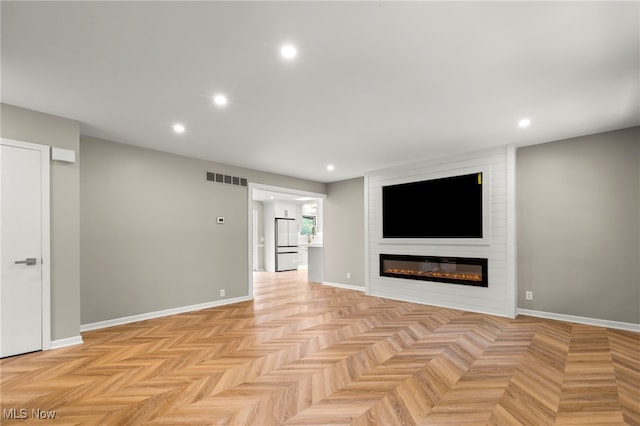 unfurnished living room with recessed lighting, a large fireplace, and baseboards
