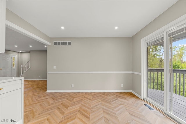 unfurnished room with baseboards, stairs, and recessed lighting