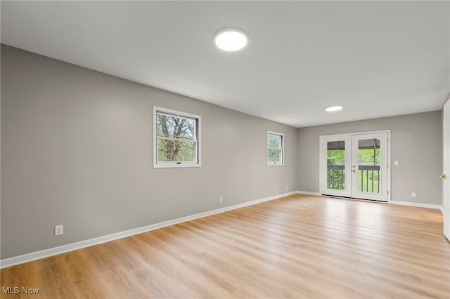 empty room featuring light wood-style flooring and baseboards