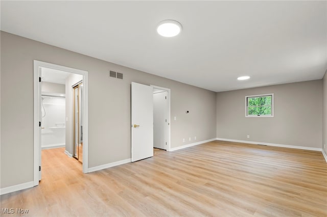 unfurnished bedroom with light wood finished floors and baseboards