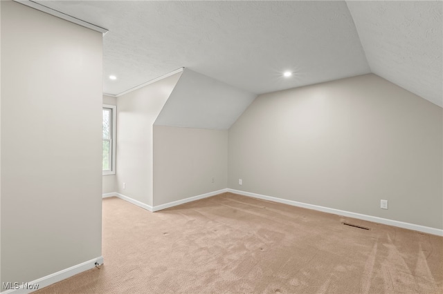 additional living space featuring vaulted ceiling, baseboards, carpet flooring, and recessed lighting
