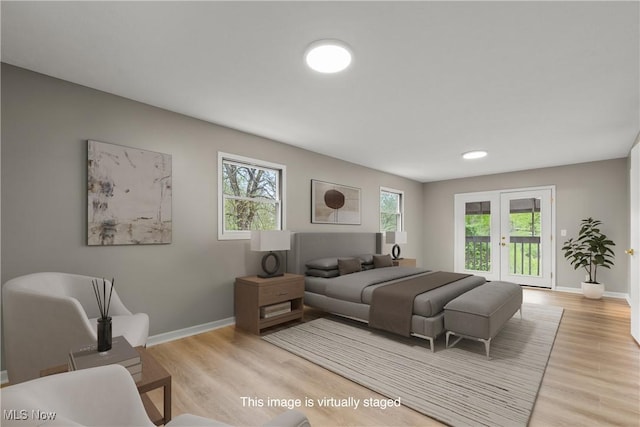 living area featuring plenty of natural light, baseboards, and light wood finished floors