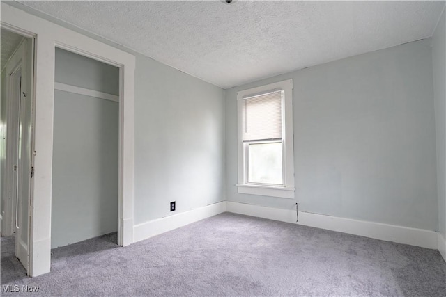 unfurnished bedroom featuring carpet flooring and a textured ceiling