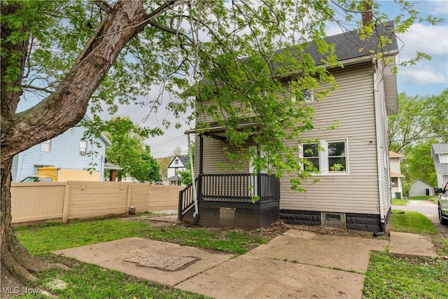 rear view of property with fence
