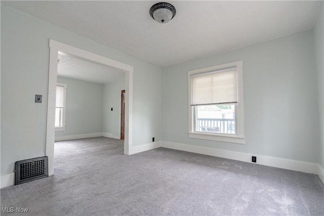 carpeted spare room with baseboards