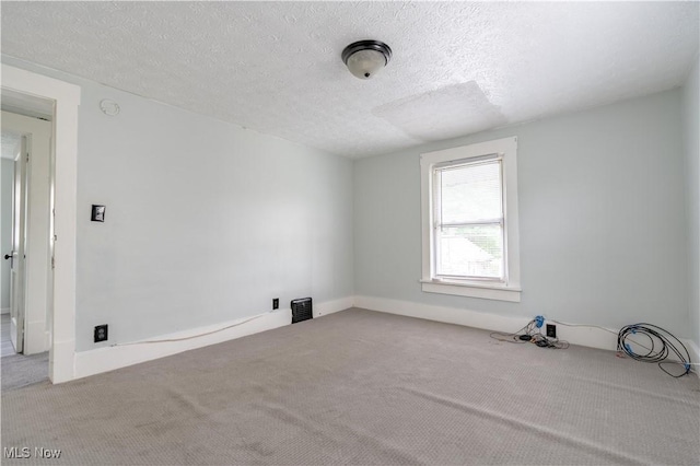 unfurnished room featuring carpet flooring and a textured ceiling