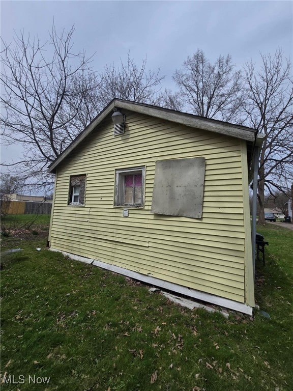 view of side of home featuring a yard
