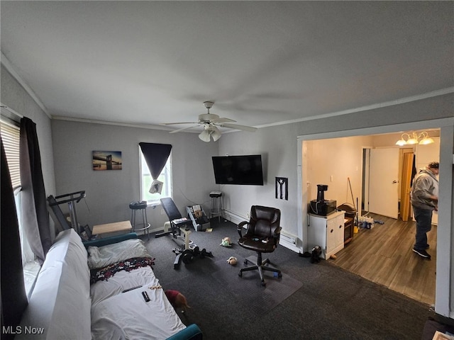 exercise room featuring ornamental molding, a ceiling fan, baseboards, and wood finished floors