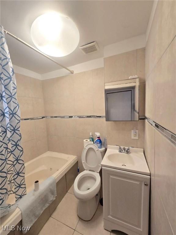 4385 Burkey Rd, Austintown, OH 44515 - bathroom featuring tile walls, toilet, tile patterned floors, shower / bath combo with shower curtain, and vanity