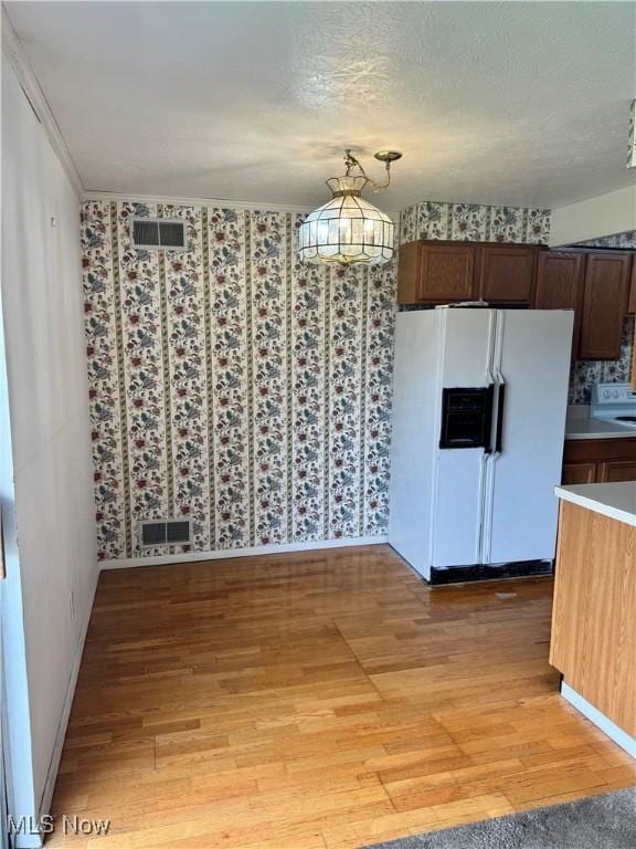 21841 River Oaks Dr Unit B4, Rocky River, OH 44116 - unfurnished dining area featuring light wood finished floors, wallpapered walls, and baseboards