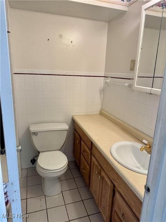 21841 River Oaks Dr Unit B4, Rocky River, OH 44116 - bathroom with vanity, tile patterned floors, tile walls, toilet, and wainscoting