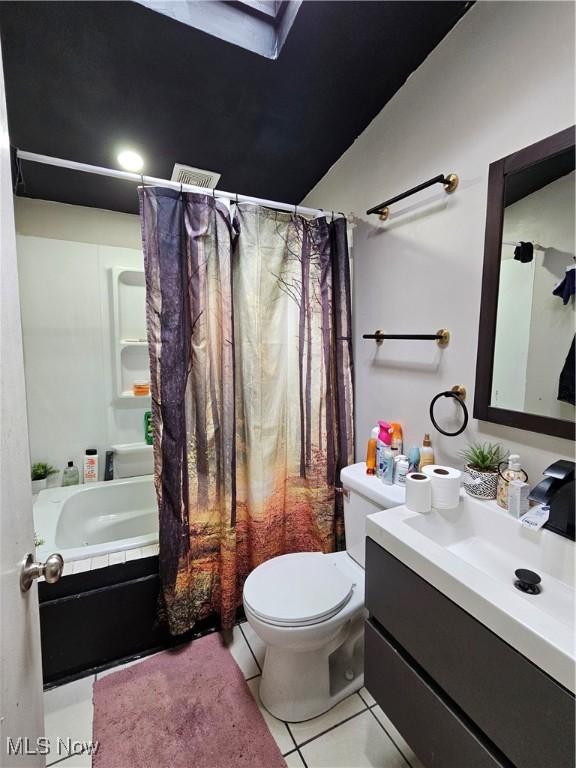 full bath with tile patterned floors, toilet, shower / bathtub combination with curtain, and vanity