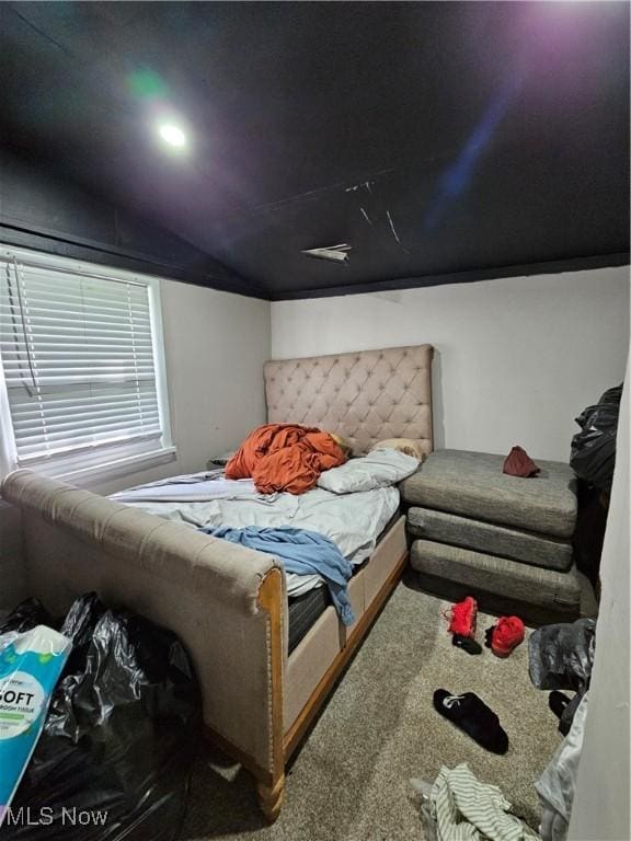 bedroom featuring lofted ceiling and carpet flooring