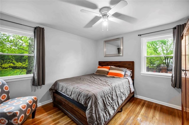 2508 Ashurst Rd, University Heights, OH 44118 - bedroom with hardwood / wood-style floors, baseboards, and a ceiling fan