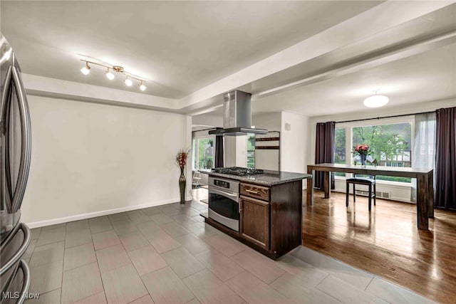 2508 Ashurst Rd, University Heights, OH 44118 - kitchen featuring appliances with stainless steel finishes, island exhaust hood, dark brown cabinetry, and plenty of natural light