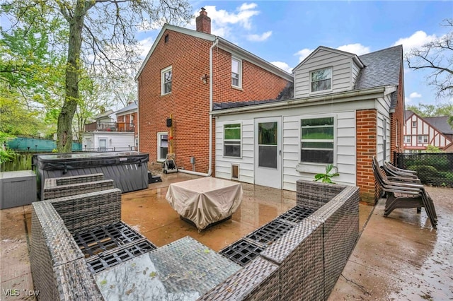 2508 Ashurst Rd, University Heights, OH 44118 - rear view of house with a hot tub, a deck, brick siding, and fence