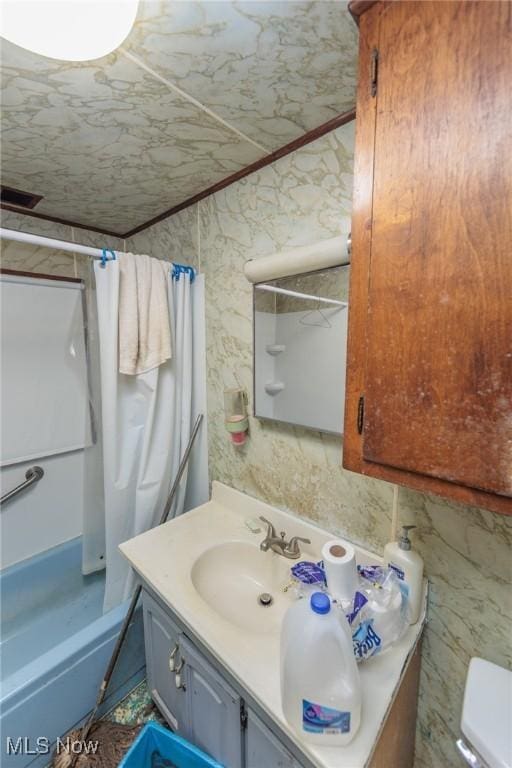 full bathroom featuring vanity, toilet, and shower / bath combination with curtain