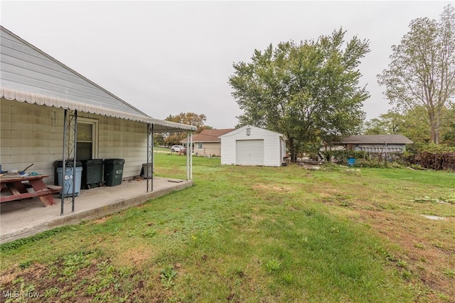 view of grassy yard featuring an outdoor structure and a patio