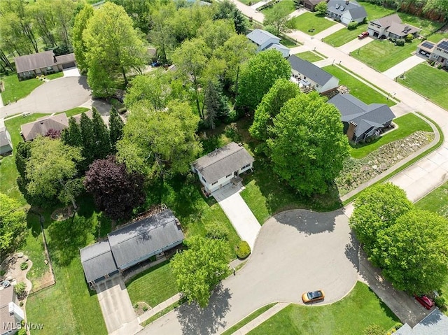 aerial view of property and surrounding area featuring nearby suburban area