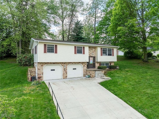bi-level home featuring an attached garage, brick siding, driveway, and a front yard