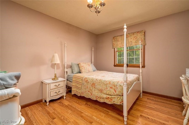 bedroom featuring light wood-style floors and baseboards