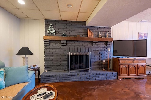 living room featuring a brick fireplace