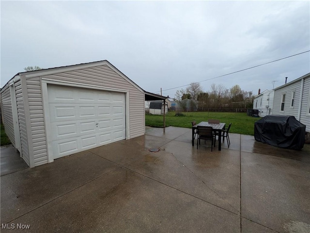 detached garage with concrete driveway