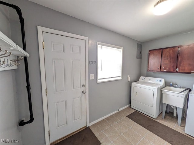 washroom featuring washer / clothes dryer, cabinet space, and baseboards