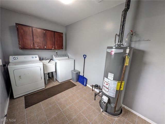 washroom with cabinet space, water heater, washer and dryer, and baseboards