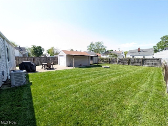 view of yard featuring an outdoor structure, a patio area, and central air condition unit
