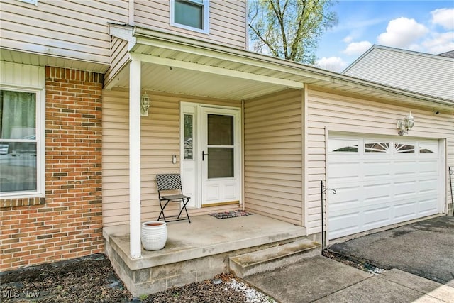4815 Shadow Oak Dr, Austintown, OH 44515 - doorway to property featuring brick siding, an attached garage, asphalt driveway, and covered porch