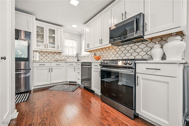 4815 Shadow Oak Dr, Austintown, OH 44515 - kitchen featuring stainless steel appliances, white cabinets, dark wood-style floors, decorative backsplash, and glass insert cabinets