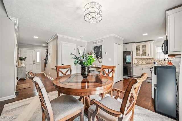 4815 Shadow Oak Dr, Austintown, OH 44515 - dining room with wood finished floors, ornamental molding, baseboards, and recessed lighting