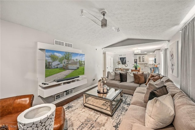 4815 Shadow Oak Dr, Austintown, OH 44515 - living area with vaulted ceiling, a textured ceiling, and wood finished floors